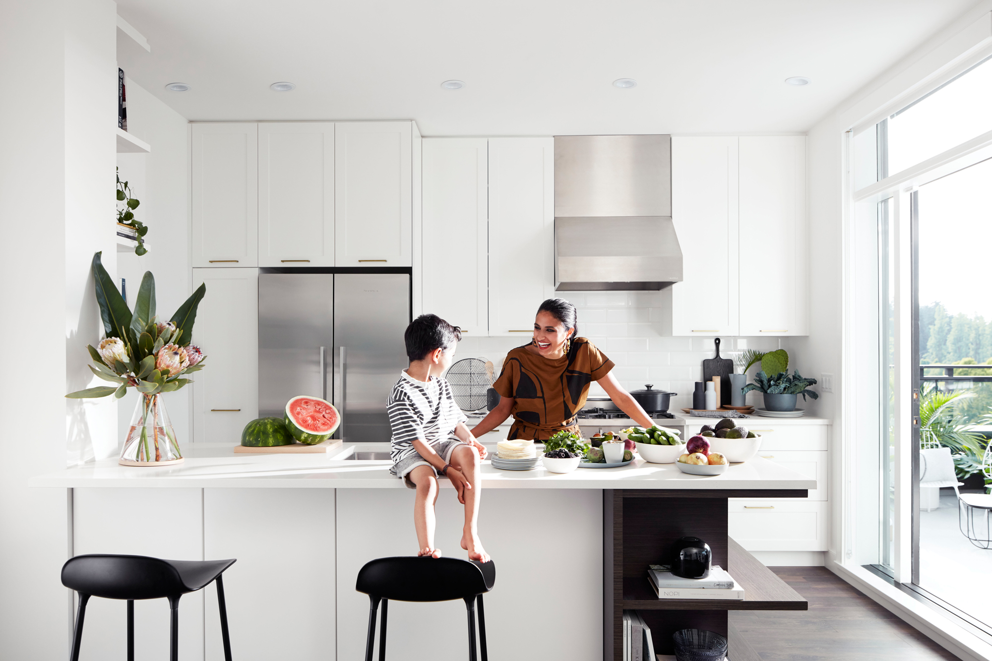 girl and young boy in kitchen talking